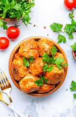 Meatballs with tomato sauce in bowl on white table background. Top view