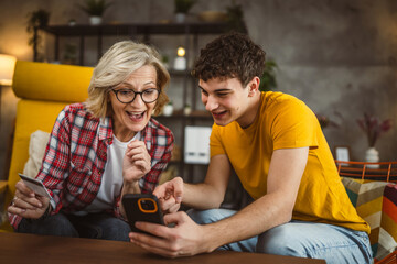 mother and son woman young man shopping online at home use credit card