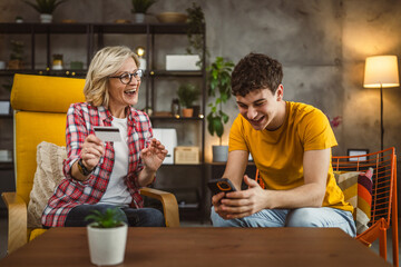 mother and son woman young man shopping online at home use credit card