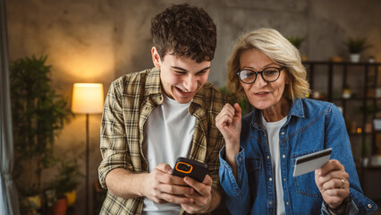 mother and son woman young man shopping online at home use credit card
