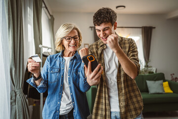 mother and son woman young man shopping online at home use credit card