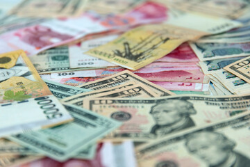 Obraz na płótnie Canvas Various paper money including USD, JPY, WON, and PESO