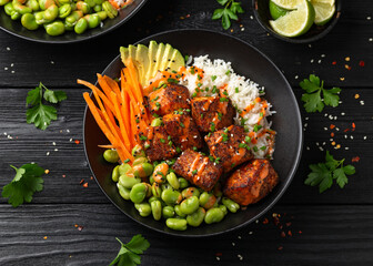 Firecracker salmon poke bowl with edamame, avocado carrot and rice
