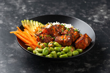 Firecracker salmon poke bowl with edamame, avocado carrot and rice