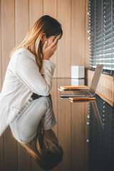 Stressed businesswoman feeling overwhelmed by work, showing signs of job fatigue and burnout in a...