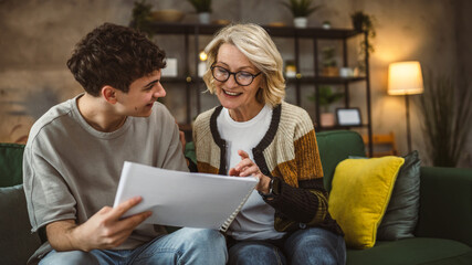 student caucasian man study with help of his tutor professor or mother