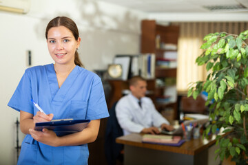 Woman doctor wear white medical uniform with folder of documents in clinic