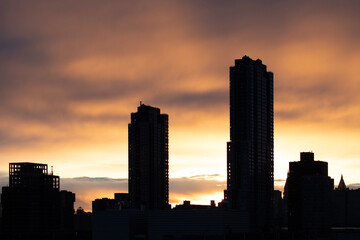 Fototapeta na wymiar Residential buildings silhouette at sunset 
