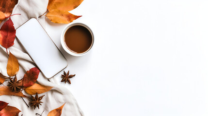 Cup of aromatic herb tea, smartphone and dry autumn leaves on white cloth