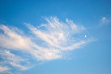 waxing moon among gentle cirrus clouds