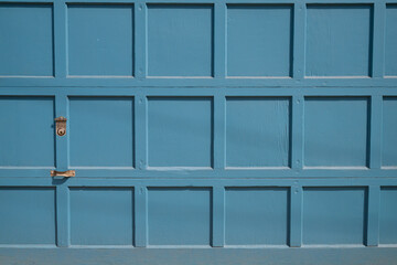 Blue wooden garage door with panels