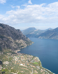 view from Monte Bestone to Limone sul Garda with a vast lake on a summer day