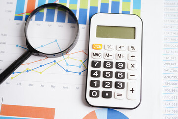 Calculator on chart graph paper. Finance, account, statistic, investment data economy, stock exchange business.