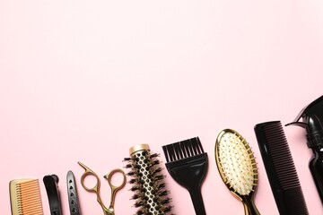 Professional hair dresser tools on pink background, flat lay. Space for text