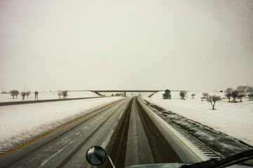 Looking Out the Windshield of a Semi Truck Driving Down the Highway in a Winter Snow
