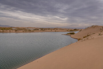 Desert vastness next to lake in Wuhai, Inner Mongolia, China