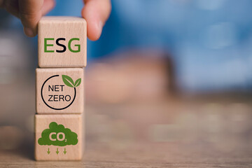 A stack of wooden blocks with the words ESG, Net Zero, and CO2 on them