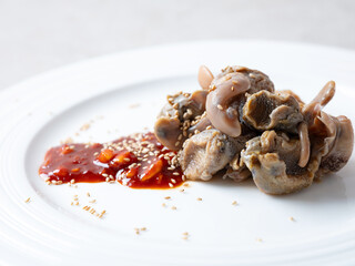 Boiled whelk with spicy sauce on a plate
