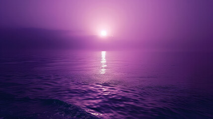 A beautiful purple ocean with a sun setting in the background