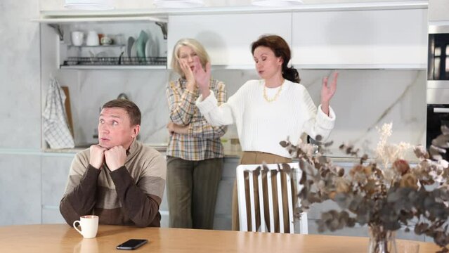 Family quarrel, two women of differen age blaming man. Family quarrel of three people. High quality 4k footage