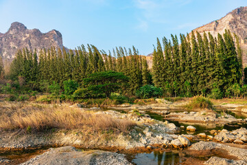 Beautiful view of landscape concave and complex mountains with reflection on lake and blue sky...