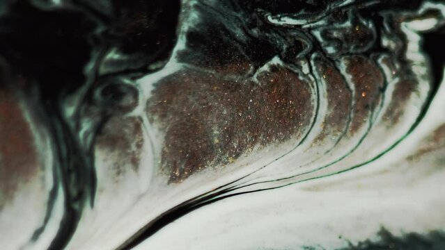 Marble ink. Paint flow. White bronze brown black color shimmering glitter fluid water mix wave motion vein texture abstract art background.