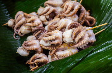 Baby octopus satay at a restaurant ready to be fried or grilled before serving.