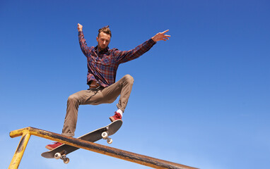 Fitness, energy and man with skateboard, jump or rail balance at a skate park for stunt training....