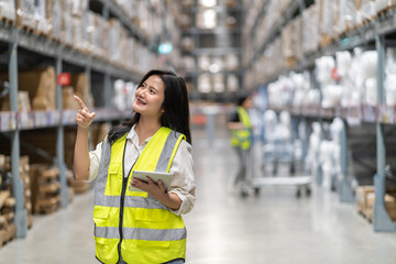 Female engineer is handling shipping and checking stock inventory in the warehouse with a tablet, industry, import-export, inventory management, logistics, global transportation at warehouse, business