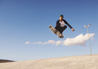 Skateboard, blue sky and man with ramp, challenge and training for a competition, talent and...