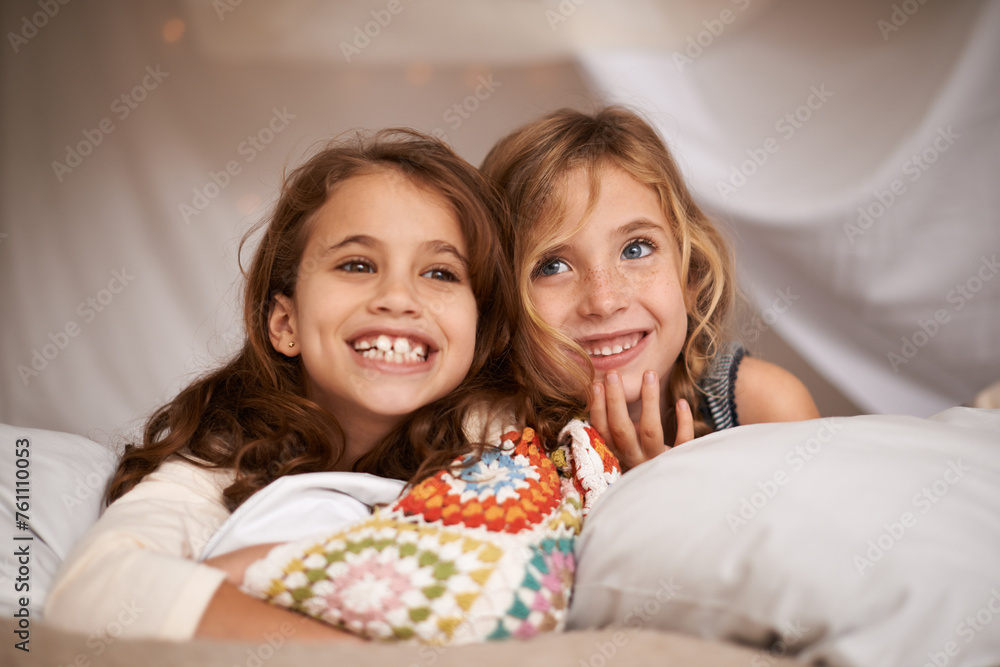 Sticker Happy, sleepover and face of children in bedroom for playing, bonding and relax with toys in home. Laughing, friends and young girls on bed in tent or blanket fort for childhood, fun and happiness