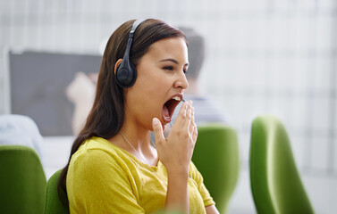 Woman, headset and yawn or tired in call centre, burnout and mental health for fatigue at helpdesk....