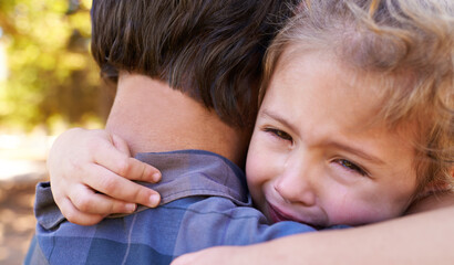 Hug, sad girl and father in a park, emotions and expression with reaction and crying with single parent. Loss, family and outdoor with dad and daughter with embrace and grief with tears, adhd or pain