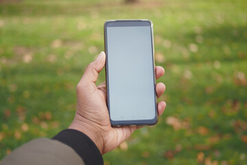 rear view of young man using smart phone at outdoor 