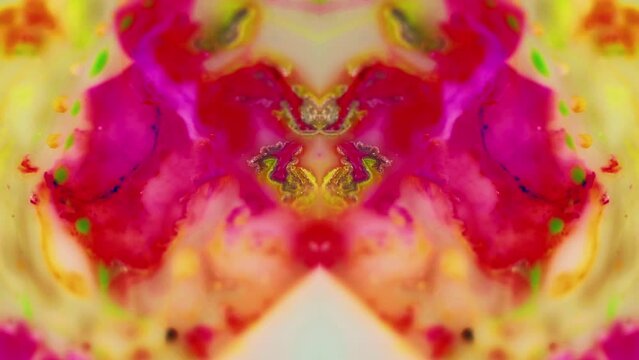 Paint mix. Ink kaleidoscope. Fantasy orchid flower. Defocused yellow magenta pink color acrylic dye fluid water blend flow motion symmetrical ornament abstract art background.