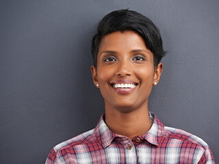Happy, portrait and Indian person with smile with gray background at a creative agency office....