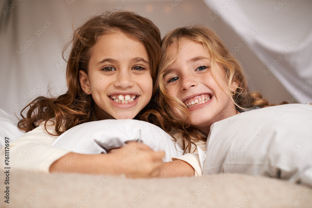 Poster Excited, sleepover and portrait of children in bedroom for playing, bonding and relax with toys in home. Happy, friends and young girls on bed in tent or blanket fort for childhood, fun and happiness