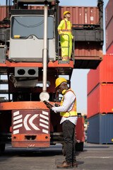 African logistic engineer man worker or foreman working direct driver forklift container at container site	 - 761121635