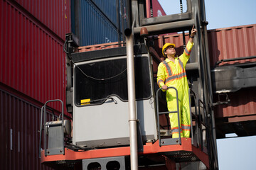 Asia logistic engineer man worker or foreman working direct driver forklift container at container site	 - 761121657