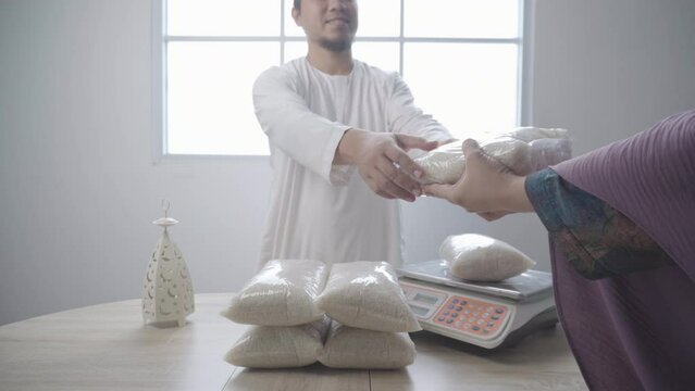 Muslim Man Giving Rice for Poor Woman. Zakat For Islamic Charity and Donation on Ramadan and Eid. 