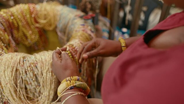 African Woman making handmade beads