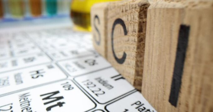 Wooden cubes in row on desk creating word Science in office