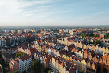 Fototapeta na wymiar Beautiful panoramic architecture of old town in Gdansk, Poland at sunrise. Aerial view drone pov. Landscape cityscape City from Above. Small vintage historical buildings Europe Tourist Attractions 
