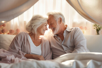 An elderly man and woman sit closely together on a bed, showcasing love and companionship in their golden years - Powered by Adobe