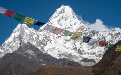 Prayer flags hanging in front of Mt.Ama Dablam (6,812 m) one of the most beautiful mountains in the world seen from Sagarmatha national park, Nepal.