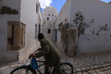 person riding a bicycle qayeawan, tunisia