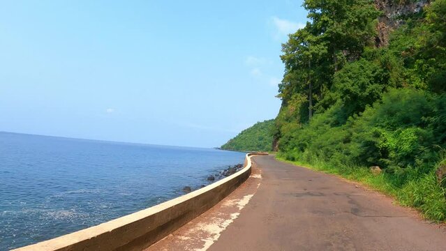 POV shot at a coastal road  at famouse Santa Catarina road in north of São Tomé,Africa