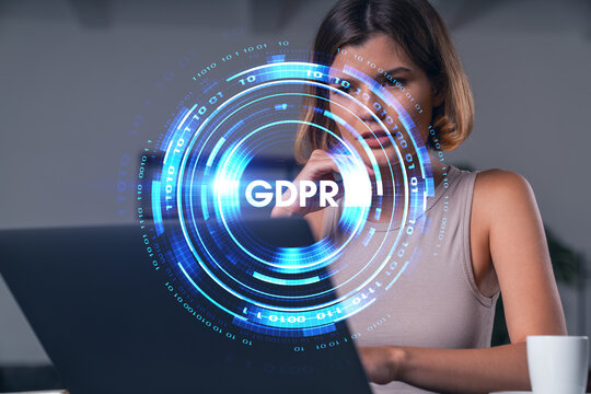 Thoughtful businesswoman in casual wear typing on laptop at office workplace with coffee cup. Concept of distant work, business, internet surfing, information technology. Data security hologram