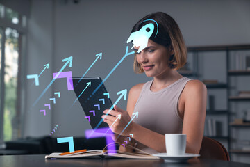 Fototapeta na wymiar Smiling businesswoman in casual wear holding tablet device touching it at office workplace. Concept of distant work, business education, information technology. Start up hologram