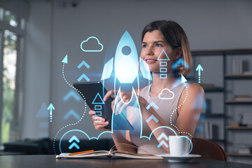 Smiling businesswoman in casual wear holding tablet device touching it at office workplace. Concept...